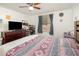 Bedroom featuring a ceiling fan, full dresser, and window with blue curtains at 537 Martin Place Blvd, Apopka, FL 32712