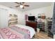 Bedroom featuring a ceiling fan, full dresser, storage for shoes and reading material at 537 Martin Place Blvd, Apopka, FL 32712