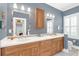 Bathroom boasts a double vanity, wood cabinetry, and tiled mirrors with excellent lighting at 616 Sheridan Blvd, Orlando, FL 32804