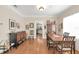 Well-lit dining room featuring hardwood floors, a wooden dining table, and a stylish display cabinet at 616 Sheridan Blvd, Orlando, FL 32804