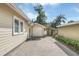 Paver driveway leading to a detached two car garage with backyard access through a wooden gate at 616 Sheridan Blvd, Orlando, FL 32804