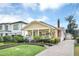 Inviting home showcasing meticulous landscaping, brick driveway, and a charming porch adorned with flower boxes at 616 Sheridan Blvd, Orlando, FL 32804