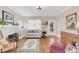 Inviting living room with a white fireplace, hardwood floors, and a charming view of the front porch at 616 Sheridan Blvd, Orlando, FL 32804