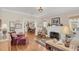 Warm living room featuring hardwood floors, a decorative fireplace, and comfortable seating arrangements at 616 Sheridan Blvd, Orlando, FL 32804