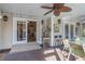 Covered brick patio with ceiling fan, bar seating, and view of the kitchen through french doors at 616 Sheridan Blvd, Orlando, FL 32804