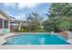 Beautiful in-ground swimming pool with tiled trim and views of the backyard landscaping at 616 Sheridan Blvd, Orlando, FL 32804