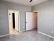 Bedroom features tile flooring, and entrances to a bathroom and closet, creating a suite at 6408 Raleigh St # 2402, Orlando, FL 32835