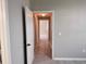 Hallway with an open door showcasing tiled floors, leading to various rooms in the house at 6408 Raleigh St # 2402, Orlando, FL 32835