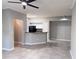 Spacious living area with tile floors, ceiling fan, and open kitchen with modern appliances at 6408 Raleigh St # 2402, Orlando, FL 32835