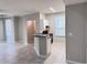 Open-concept living space with kitchen bar, tile flooring, and modern appliances at 6408 Raleigh St # 2402, Orlando, FL 32835