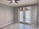 Living room featuring tile floors, ceiling fan, neutral walls, and bright window at 6408 Raleigh St # 2402, Orlando, FL 32835