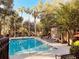 Community pool with lounge chairs and lush landscaping, perfect for relaxation and socializing at 6408 Raleigh St # 2402, Orlando, FL 32835