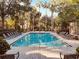 Community swimming pool with lounge chairs and landscaping, perfect for relaxation at 6408 Raleigh St # 2402, Orlando, FL 32835