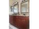 Spacious double sink bathroom vanity with granite countertop, brown cabinets and bronze fixtures at 7138 Hiawassee Bent Cir, Orlando, FL 32818