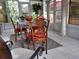 Sunroom dining area with classic furniture, tile flooring, and natural light at 7138 Hiawassee Bent Cir, Orlando, FL 32818