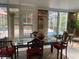 Bright sunroom dining area featuring elegant table set and pool view at 7138 Hiawassee Bent Cir, Orlando, FL 32818