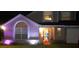 Exterior view of a home with a pink glow showcasing its architectural details and landscaping at 7138 Hiawassee Bent Cir, Orlando, FL 32818