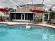 Sparkling swimming pool with lounge seating and covered patio area at 7138 Hiawassee Bent Cir, Orlando, FL 32818