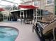 Outdoor patio featuring poolside furniture and lanai with a relaxing setting at 7138 Hiawassee Bent Cir, Orlando, FL 32818