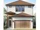 Charming two-story home featuring a symmetrical facade, a two-car garage, and modern architectural details at 7433 Excitement Dr, Reunion, FL 34747