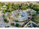 Aerial view of a colorful resort water park with slides, sprinklers, and plenty of seating at 7433 Excitement Dr, Reunion, FL 34747