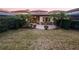 Backyard with a brick patio, manicured landscaping, and privacy hedges at 8348 Via Rosa, Orlando, FL 32836