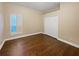 Bright bedroom with hardwood floors, shuttered window, and a spacious closet at 8348 Via Rosa, Orlando, FL 32836