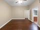 Spacious bedroom with hardwood floors and a view into the bathroom at 8348 Via Rosa, Orlando, FL 32836