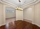 Elegant dining room with chandelier and archways, connecting to other living spaces at 8348 Via Rosa, Orlando, FL 32836