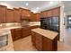 Well-equipped kitchen featuring sleek black stainless appliances, wine rack, and ample counter space at 8348 Via Rosa, Orlando, FL 32836