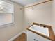 Laundry room with sink, cabinet, and window for natural light at 8348 Via Rosa, Orlando, FL 32836