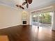 Bright and airy living room featuring patio doors, hardwood floors, and decorative fireplace at 8348 Via Rosa, Orlando, FL 32836