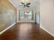 Living room with decorative accent wall, hardwood flooring, and large window offering natural light at 8348 Via Rosa, Orlando, FL 32836