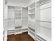 Spacious walk-in closet with custom white shelving and dark hardwood floors at 8348 Via Rosa, Orlando, FL 32836