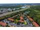 Overhead shot featuring community buildings with red tile roofs, ample parking, and lush surroundings near a highway and lakes at 8523 Crystal Cove Loop, Kissimmee, FL 34747