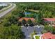 Community buildings with terracotta roofs and a parking area next to a scenic pond, lush greenery, and a highway at 8523 Crystal Cove Loop, Kissimmee, FL 34747