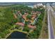 Aerial view of townhome community surrounded by trees and a highway at 8523 Crystal Cove Loop, Kissimmee, FL 34747