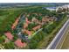 Aerial view of a townhome community with nearby highway and lake at 8523 Crystal Cove Loop, Kissimmee, FL 34747