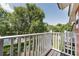 Outdoor balcony with green trees and a view of the lake at 8523 Crystal Cove Loop, Kissimmee, FL 34747