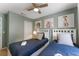 Bright bedroom with twin beds, ceiling fan, and colorful artwork at 8523 Crystal Cove Loop, Kissimmee, FL 34747