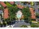 Aerial view of a sparkling community pool with lounge chairs, surrounded by well-maintained landscaping and buildings at 8523 Crystal Cove Loop, Kissimmee, FL 34747