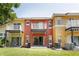 Exterior view of colorful townhomes with balconies and patios at 8523 Crystal Cove Loop, Kissimmee, FL 34747