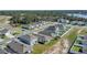 Aerial view of the property showcasing its location within a well-planned community with mature trees and a lake at 863 August Sky Dr, Deltona, FL 32738