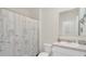 Bright bathroom featuring a shower with curtain, single sink, and clean design at 863 August Sky Dr, Deltona, FL 32738