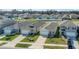 Exterior view of two homes with well-manicured lawns and driveways, featuring attached garages at 863 August Sky Dr, Deltona, FL 32738