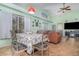 Dining area with lots of sunlight from the large windows, seamlessly flowing into the living room at 8982 Fort Jefferson Blvd, Orlando, FL 32822