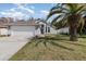 Charming single-story home with well-manicured lawn and a mature palm tree in a suburban neighborhood at 8982 Fort Jefferson Blvd, Orlando, FL 32822