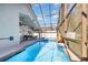 Screened-in pool with fountain, poolside seating, and clear view of the blue sky above at 8982 Fort Jefferson Blvd, Orlando, FL 32822