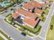 Elevated view of a residential area, displaying homes with tile roofs and a communal pool nearby at 9406 Mere Pkwy, Orlando, FL 32832