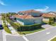 Aerial view of a modern home featuring a red tile roof, well-maintained landscaping, and a two-car garage at 9406 Mere Pkwy, Orlando, FL 32832